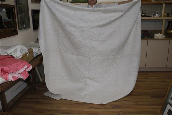 An off-white quilt with blue stitching, a reversible blue and cream quilt, a creamy oyster quilt and a mint green quilt (4)